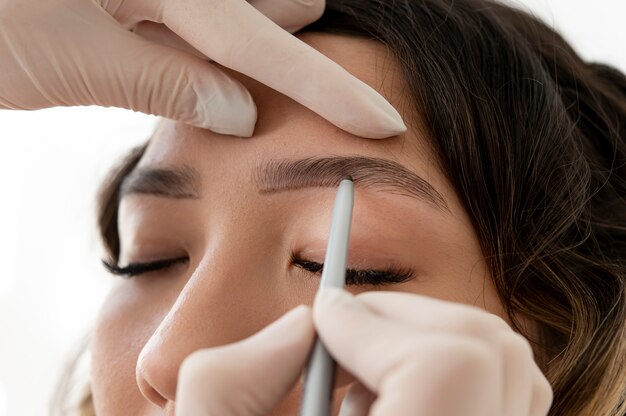 Young female client going through a microblading procedure