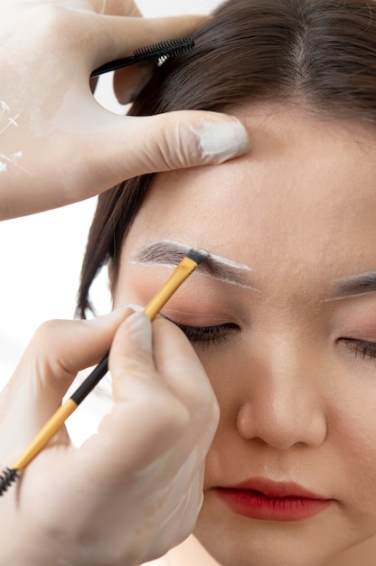 Young female client going through a microblading procedure