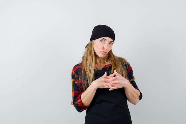 Free photo young female cook in a black apron