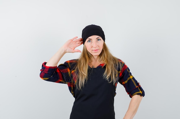 Free photo young female cook in a black apron