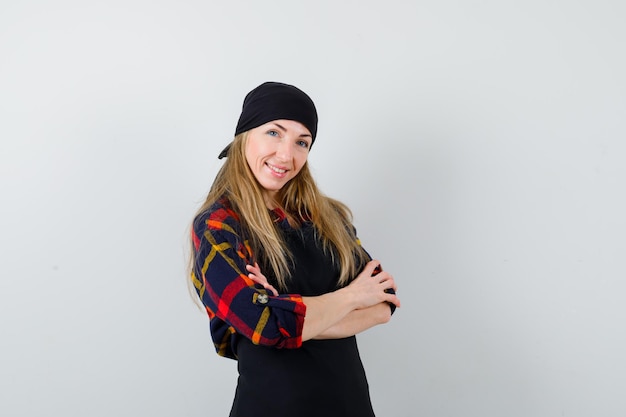 Free photo young female cook in a black apron