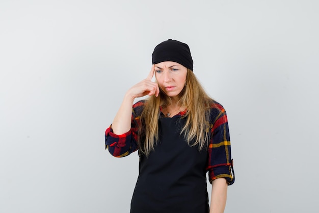 Young female cook in a black apron