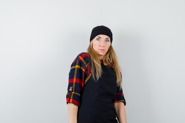 Free photo young female cook in a black apron