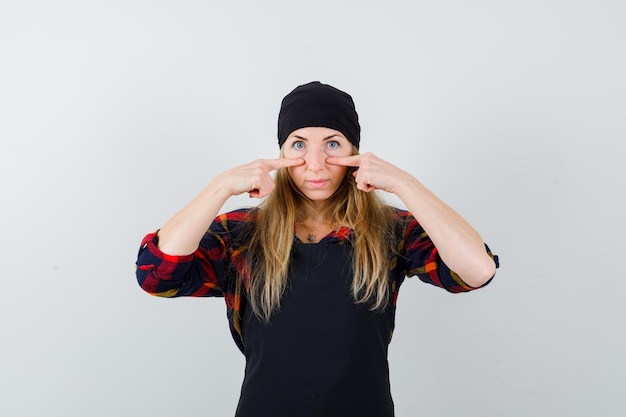 Free photo young female cook in a black apron