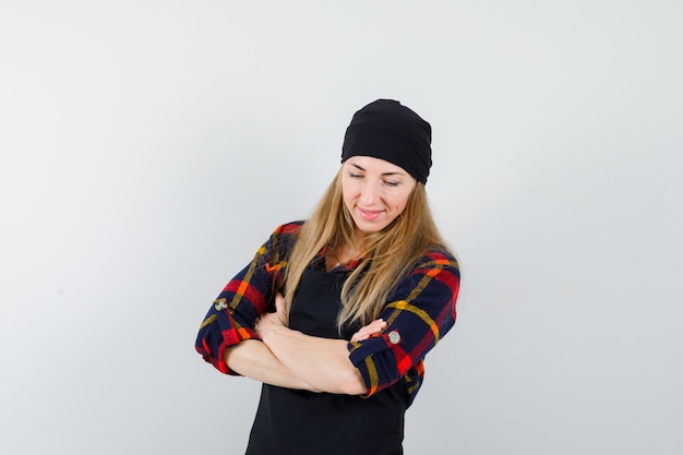 Free photo young female cook in a black apron