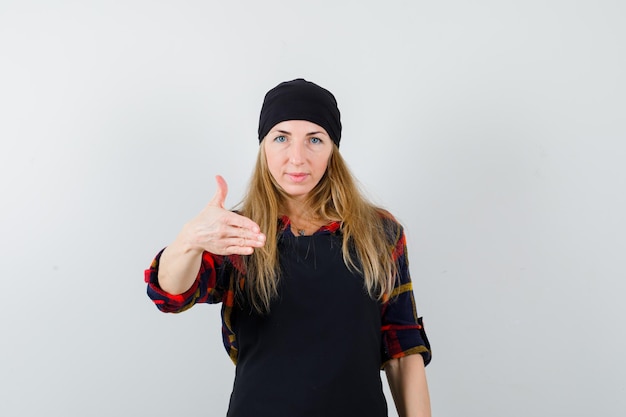 Free photo young female cook in a black apron