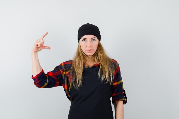 Young female cook in a black apron