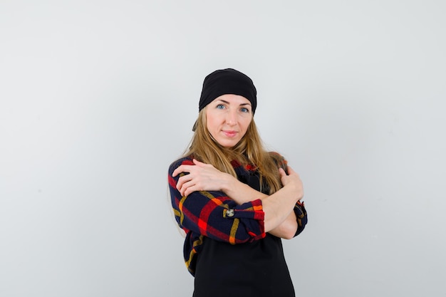 Young female cook in a black apron