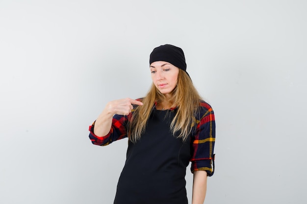 Free photo young female cook in a black apron