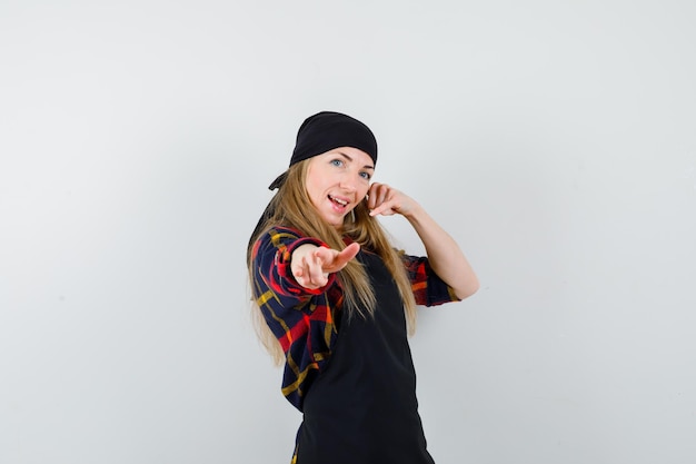 Free photo young female cook in a black apron