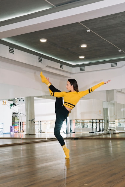 Young female dancer practising in the dance studio