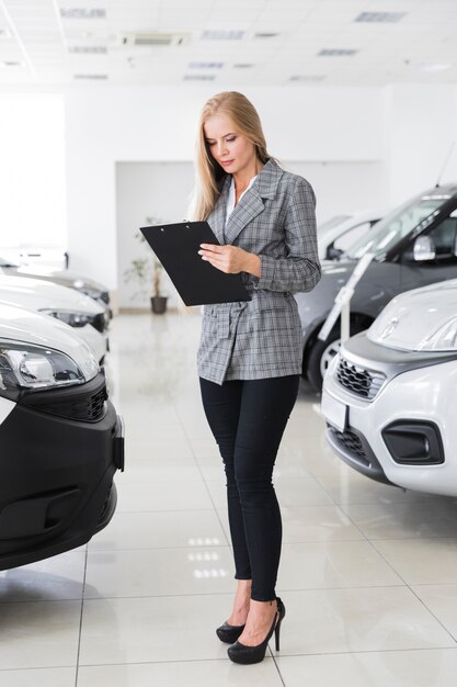 Young female dealer looking in file