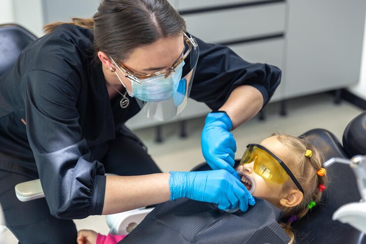 Free Photo young female dentist at work dentistry treatment of childrens teeth