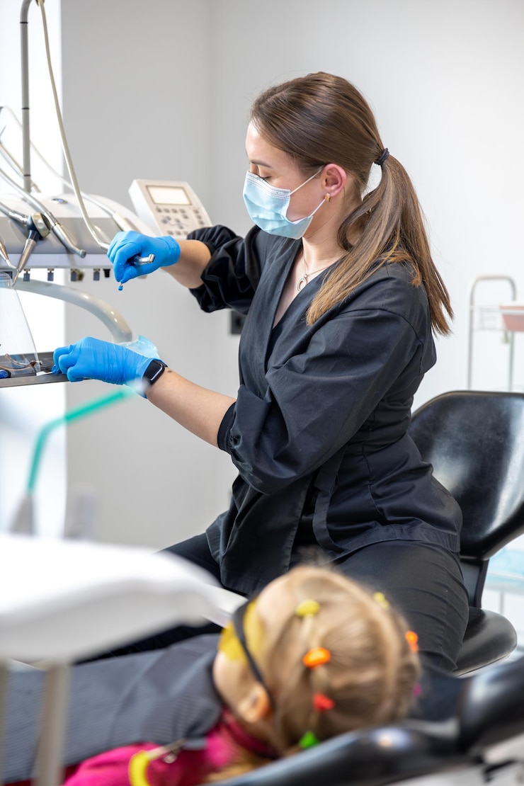 Free Photo young female dentist at work dentistry treatment of childrens teeth