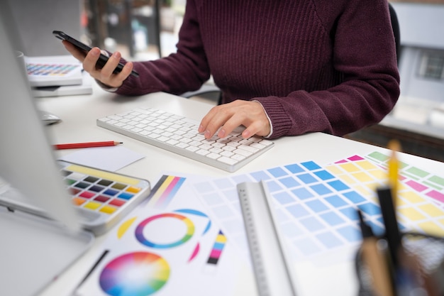 Young female designer checking her smartphone