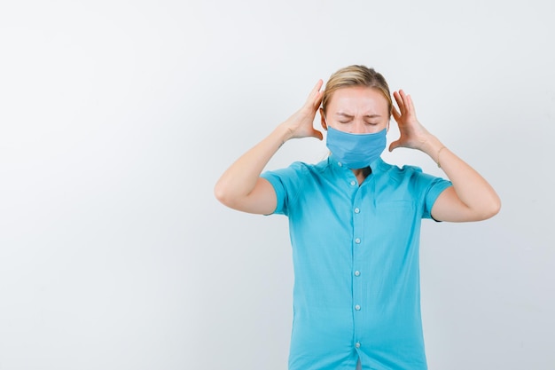 Young female doctor keeping hands in aggressive manner in uniform isolated