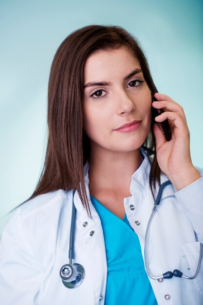 Young female doctor on the phone