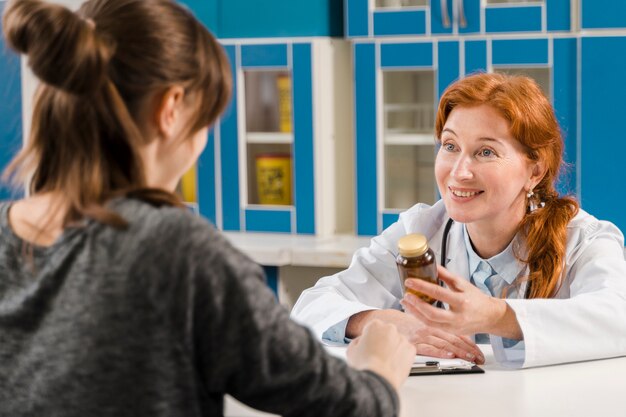 Young female doctor talking with the patient