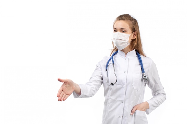 young female doctor in white medical suit in white protective mask stethoscope shaking hand on the white