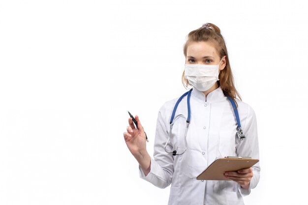 young female doctor in white medical suit with stethoscope in white protective mask on the white