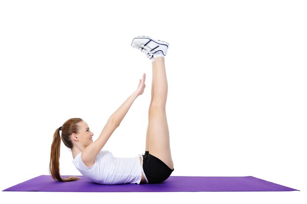 Young female doing physical exercises on the floor