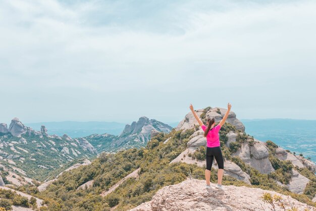 Young female enjoying the beautiful mountainous landscape in Catalonia, Spain