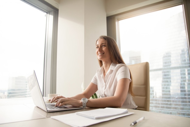 Young female entrepreneur feels happy at workplace