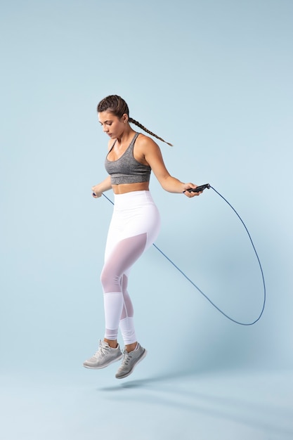 Young female exercising with a jumping rope