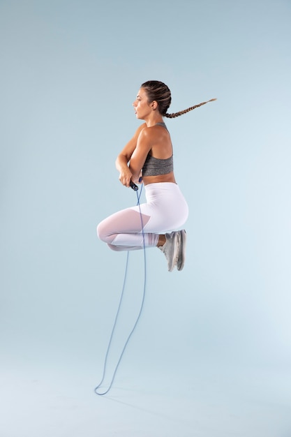 Young female exercising with a jumping rope