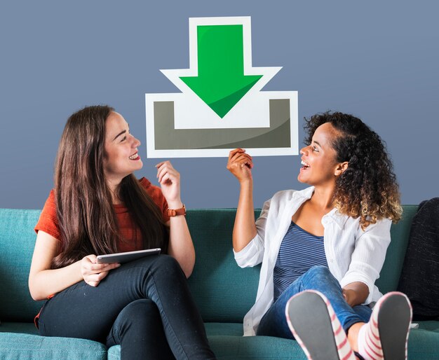 Young female friends holding a download icon