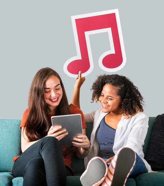 Young female friends holding a musical note icon