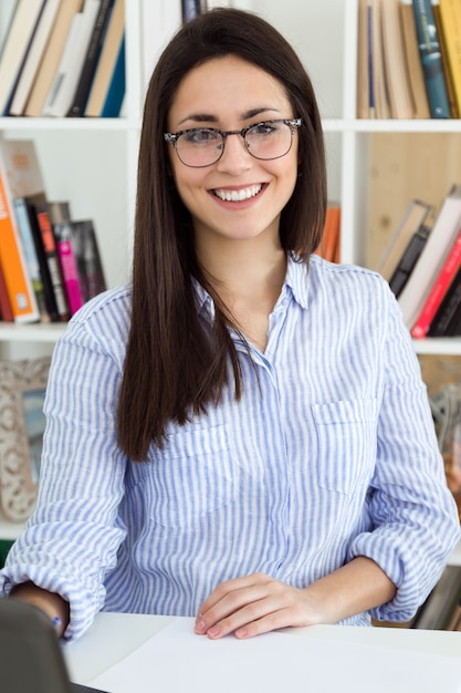 Free photo young female in glasses at workplace