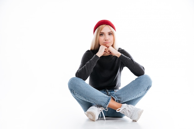 Young female hipster sitting on the floor