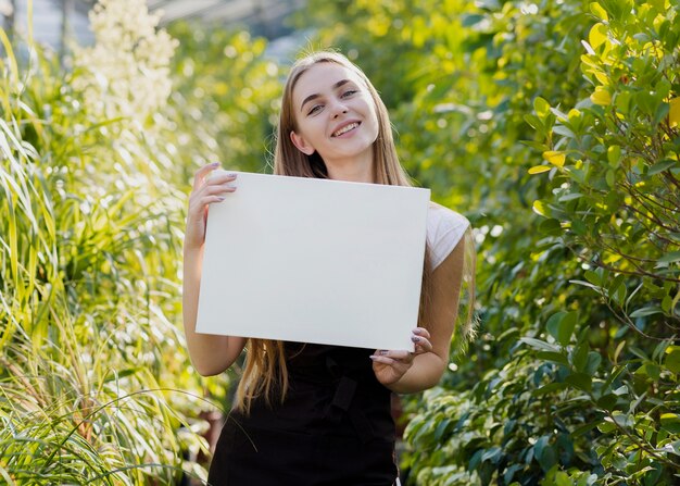 Young female holding blank sheet