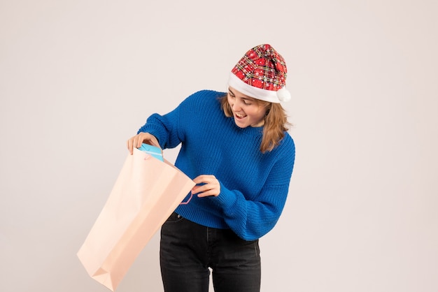 Free photo young female holding little present on white