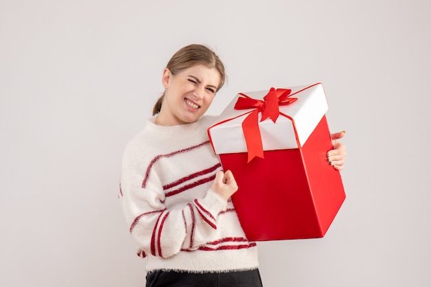 young female holding present in box on white