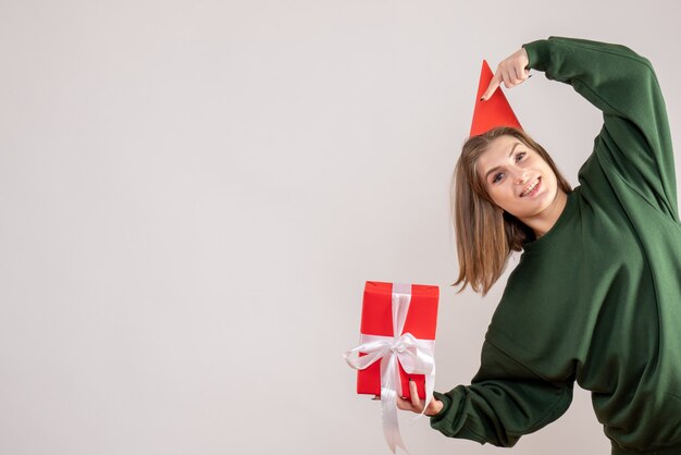 young female holding present on white