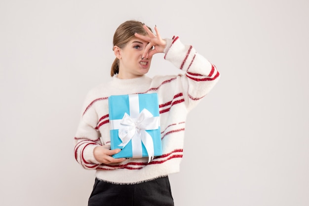 Free photo young female holding present on white