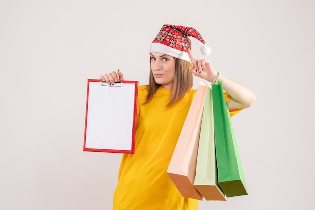 young female holding shopping packages and note on white