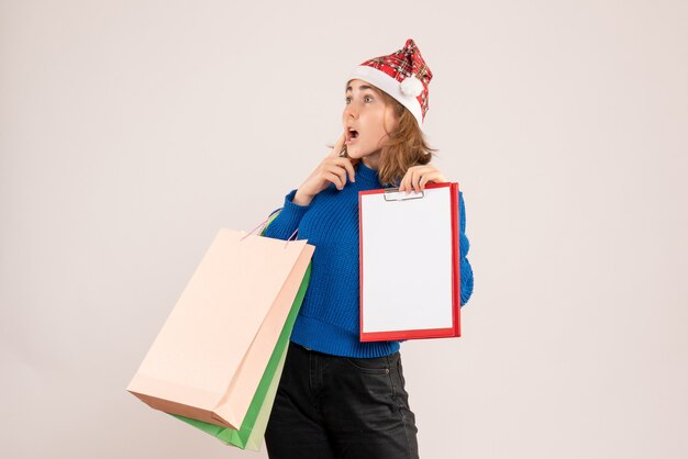 young female holding shopping packages and note on white