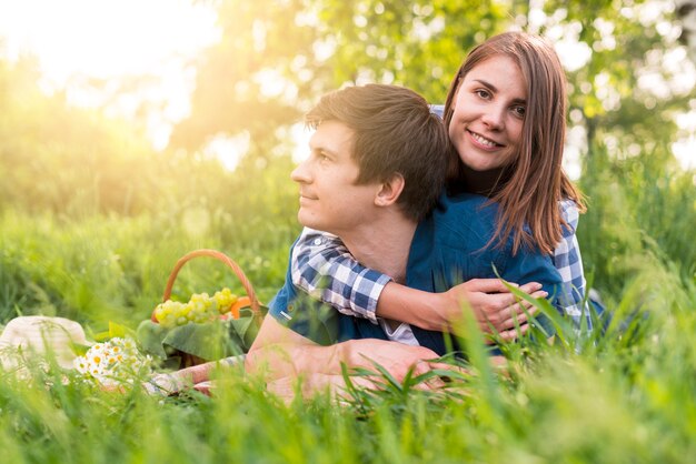 Young female hugging boyfriend on rest in nature