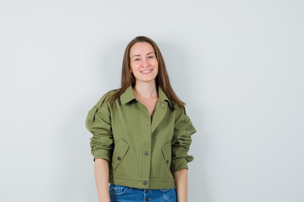 Young female in jacket, shorts and looking graceful , front view.