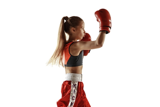 Young female kickboxing fighter training isolated on white background.