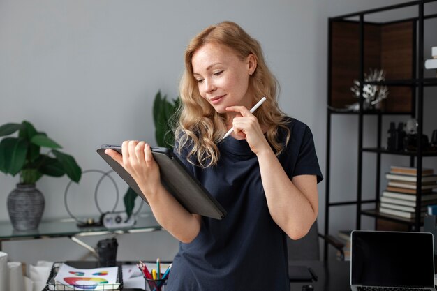 Young female logo designer working on a graphic tablet