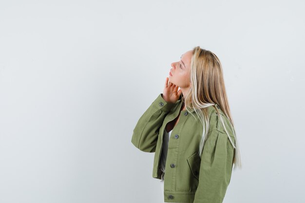 Young female looking away in jacket,blouse and looking focused. . free space for your text