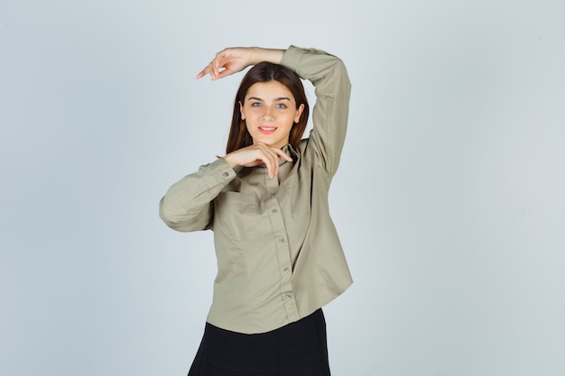 Young female making vogue pose in shirt, skirt and looking alluring