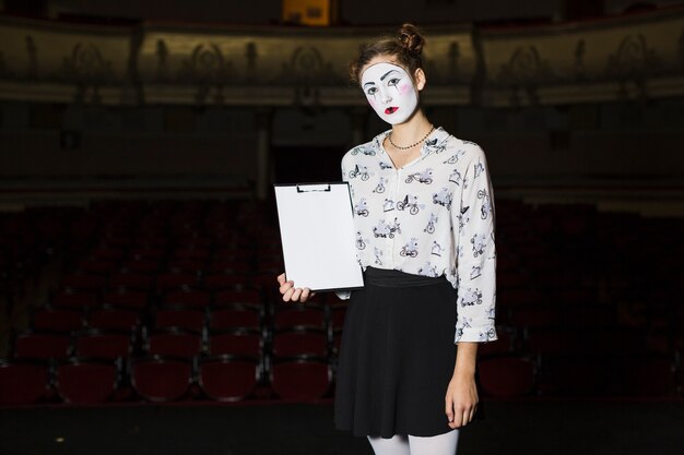 Young female mime holding manuscript