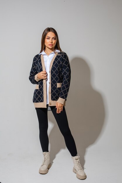 Young female model i white boots black pants checkered jacket posing to the camera