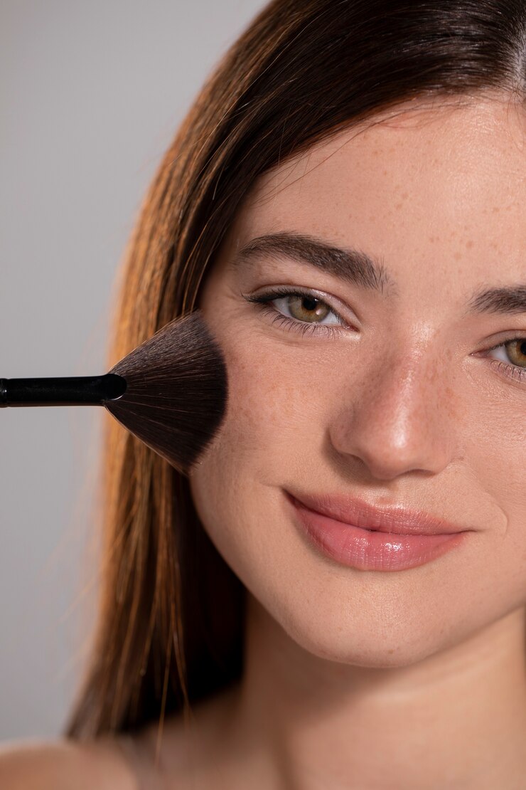 Free Photo young female model with make-up brush