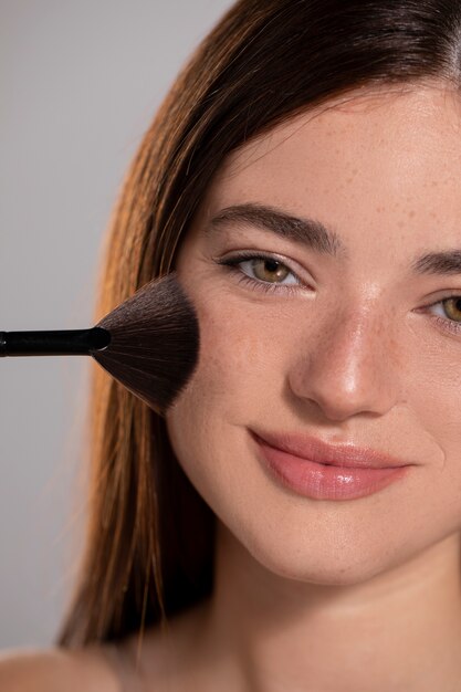 Young female model with make-up brush